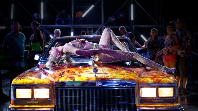 Alexia (Agathe Rousselle) writhes on top of a car in "Titane."