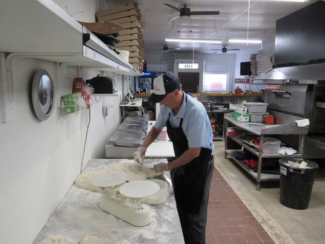 Owner Jim Douglas measures out portions of fresh dough at Papa Giorgio's, a new pizzeria at 3027 Indianola Ave. in Clintonville. It's a follow up to a store on Bethel Road.
