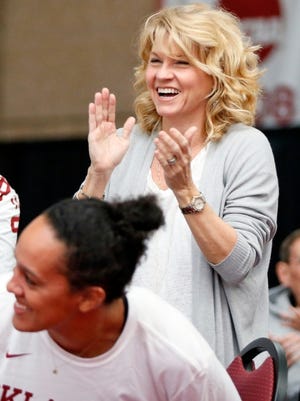 In this 2017 photo, Sherri Coale, longtime head coach of the University of Oklahoma women's basketball program, claps after her team's first game is announced on television during an NCAA women's basketball tournament watch party. Coale retired in March 2021.