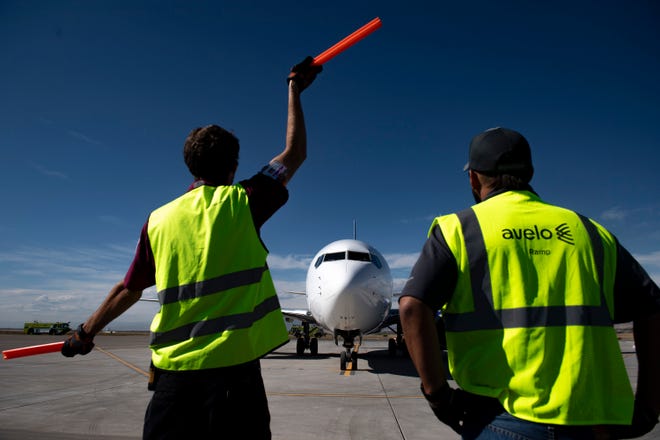Northern Colorado Regional Airport ground crews guide an Avelo Airlines' Boeing 737-700 for takeoff at the Northern Colorado Regional Airport on Oct. 6, 2021.