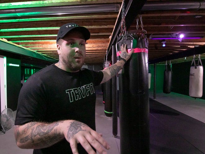 Tyler Koronich, founder of TRVFIT Fitness, talks Wednesday, Oct. 6, 2021 about upgrades coming soon to his Genoa Township location, including new boxing equipment.