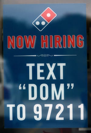 Domino’s Pizza  sign on North Mayfair Road in Wauwatosa at The Promenade is hiring for its chains. Businesses are still struggling to find employees as older workers age out of the workforce.
