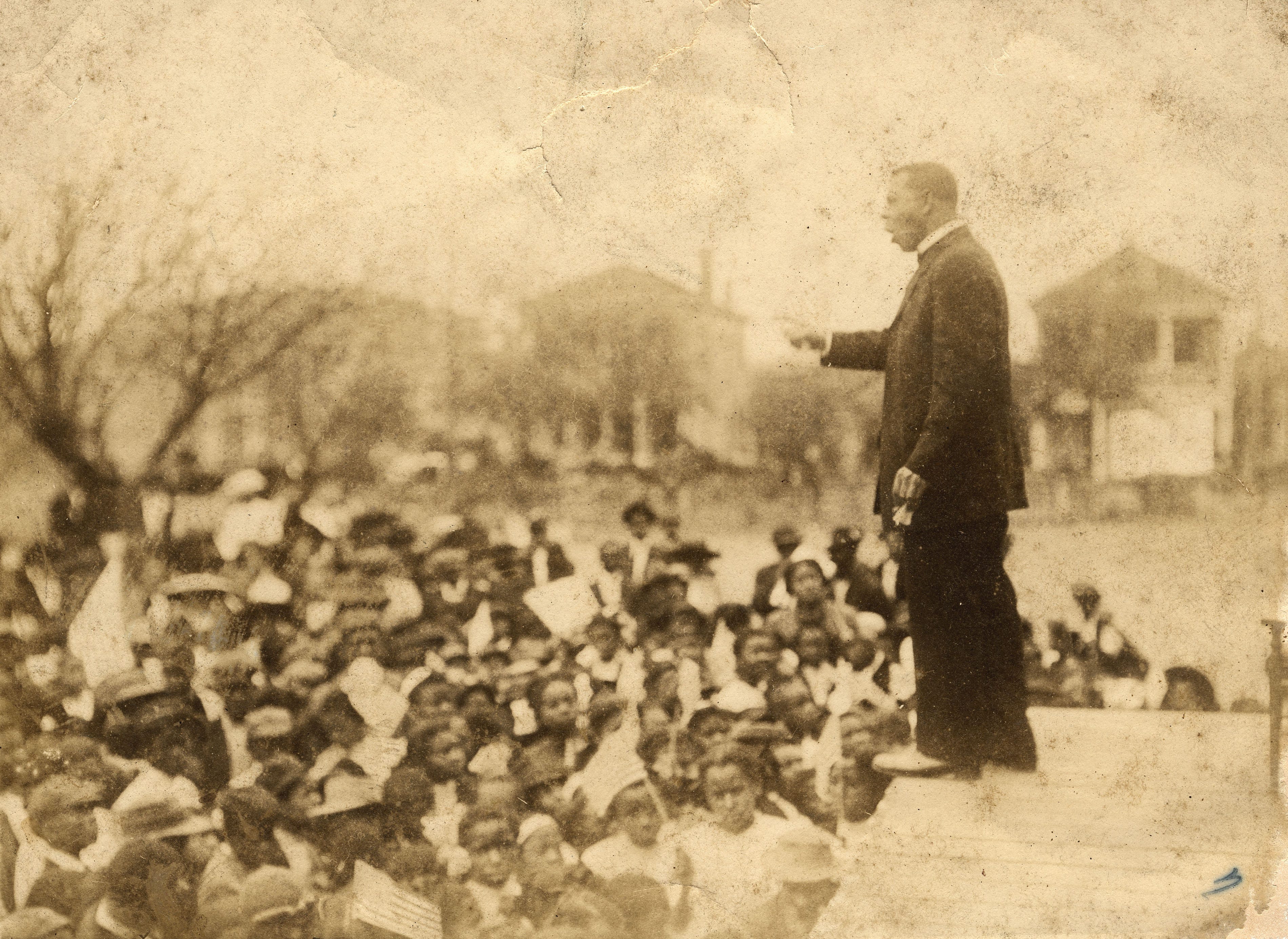 Booker T. Washington, the president of Tuskegee Institute, addresses a crowd in an undated photo. In public, Washington downplayed political activism as a way for Black Americans to reclaim their constitutional rights. In private, Washington funded numerous challenges to Jim Crow laws, and supported Jackson Giles' challenge to Alabama's constitution. Washington's role in Giles' case would not be known for more than 50 years.