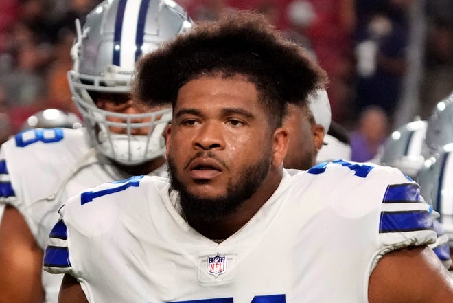 In this Aug. 13, 2021, file photo, Dallas Cowboys offensive tackle La'el Collins (71) walks off the field during a preseason NFL football game against the Arizona Cardinals in Glendale, Ariz.