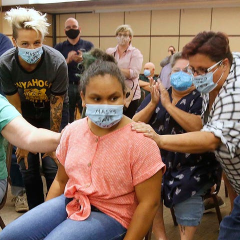 Kaylan Park, 10, returns to her seat next to her m