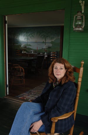 Director Gwen Wynne at the beach house in Dennis where she filmed the 2007 movie "Wild About Harry" (then known as "American Primitive"), which was based on her own adolescence. Her sister painted the mural on the wall for the film.