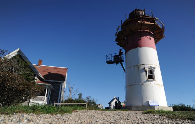 Jeremiah Berube works to remove rust around a window on Nauset Light in preparation to paint it.  The restoration work is expected to be completed by the end of this month.