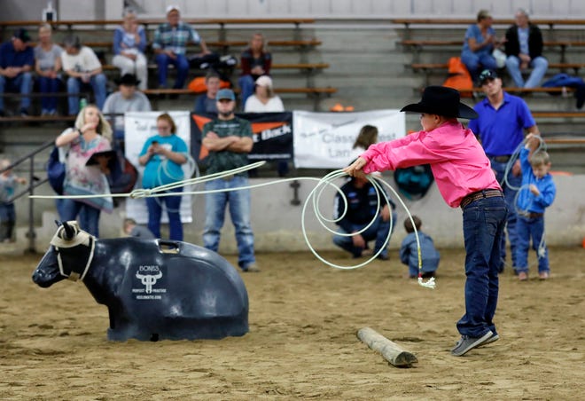 Tucker Snyder, 8, of Norwich throws his rope during the dummy roping competition in Cooper Arena at the All American Quarter Horse Congress on Thursday.