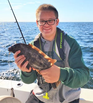 Blake Webster with one of the tautog that he and his family caught off Newport recently.