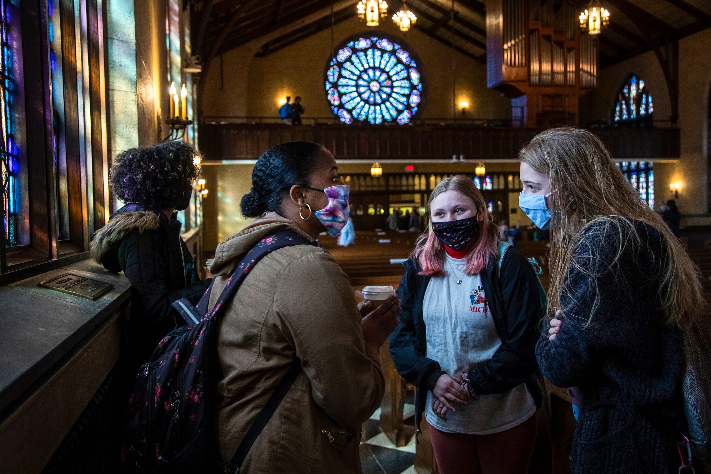 Hope College sophomore student Trinity Frye, center left, talks to Kate Kalthoff, center right, and Brianna Tomczak, both freshmen after the 10:30 a.m. worship service at the Dimnent Memorial Chapel on Hope College campus in Holland, Wednesday, March 31, 2021.