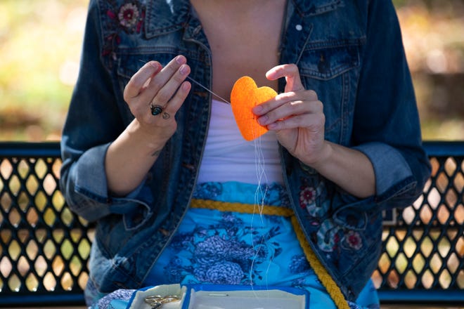 EJ Miller-Larson works on a beadwork project stitched with a porcupine quill needle Oct. 6 at Green Isle Park in Allouez. Samantha Madar/USA TODAY NETWORK-Wisconsin