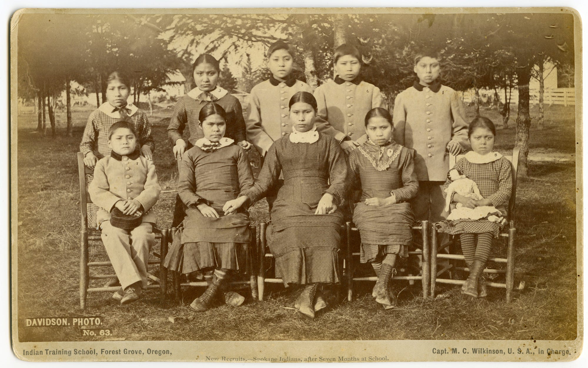 The "after" photograph, taken in March 1882 on the Forest Grove Indian School campus, shows 10 of the 11 students from the "before" photo. Martha Lot, Chief Lot's daughter, died before the second group portrait was taken.
► The intention behind the pair of photographs was to show how the school assimilates Native children into white society, erasing their Native customs.
► The public could buy copies of these portraits for 50 cents a print, with the school earning 10 cents from each sale.