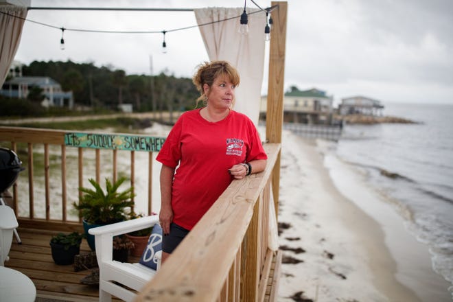 Tonya McNabb, an Alligator Point resident, looks off at the ocean from her newly constructed deck Thursday, Oct. 7, 2021. McNabb's original deck was ripped from her home during Hurricane Michael in Oct. 2018.