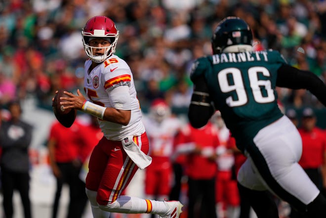 Kansas City Chiefs quarterback Patrick Mahomes (15) looks to pass in front of Philadelphia Eagles defensive end Derek Barnett (96) during the first half of an NFL football game Sunday, Oct. 3, 2021, in Philadelphia.