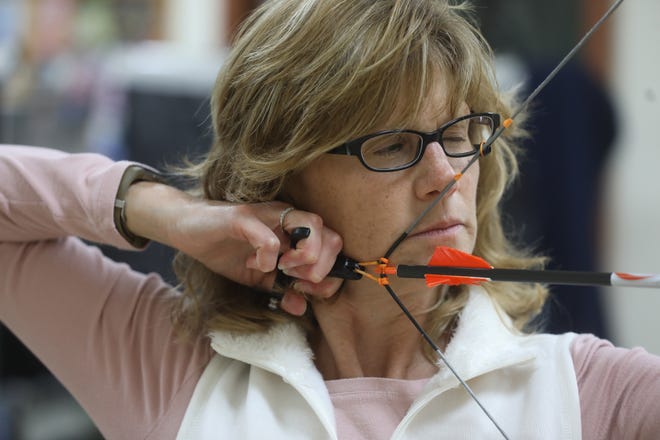 Kim Ferguson of Ionia practices at Heritage Archery Academy in Phelps, Thursday, Oct.  7, 2021. She recently won the 2021 International Bowhunting Organization Championship in her class.