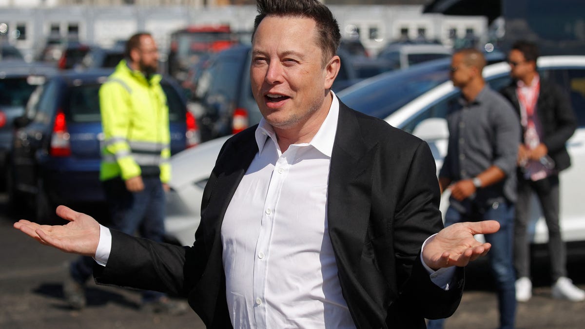 Tesla CEO Elon Musk gestures as he arrives to visit the construction site near Berlin.