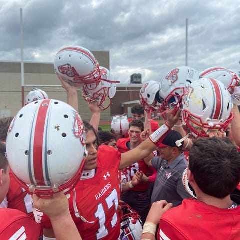 The Red Hook football team celebrates in its postg