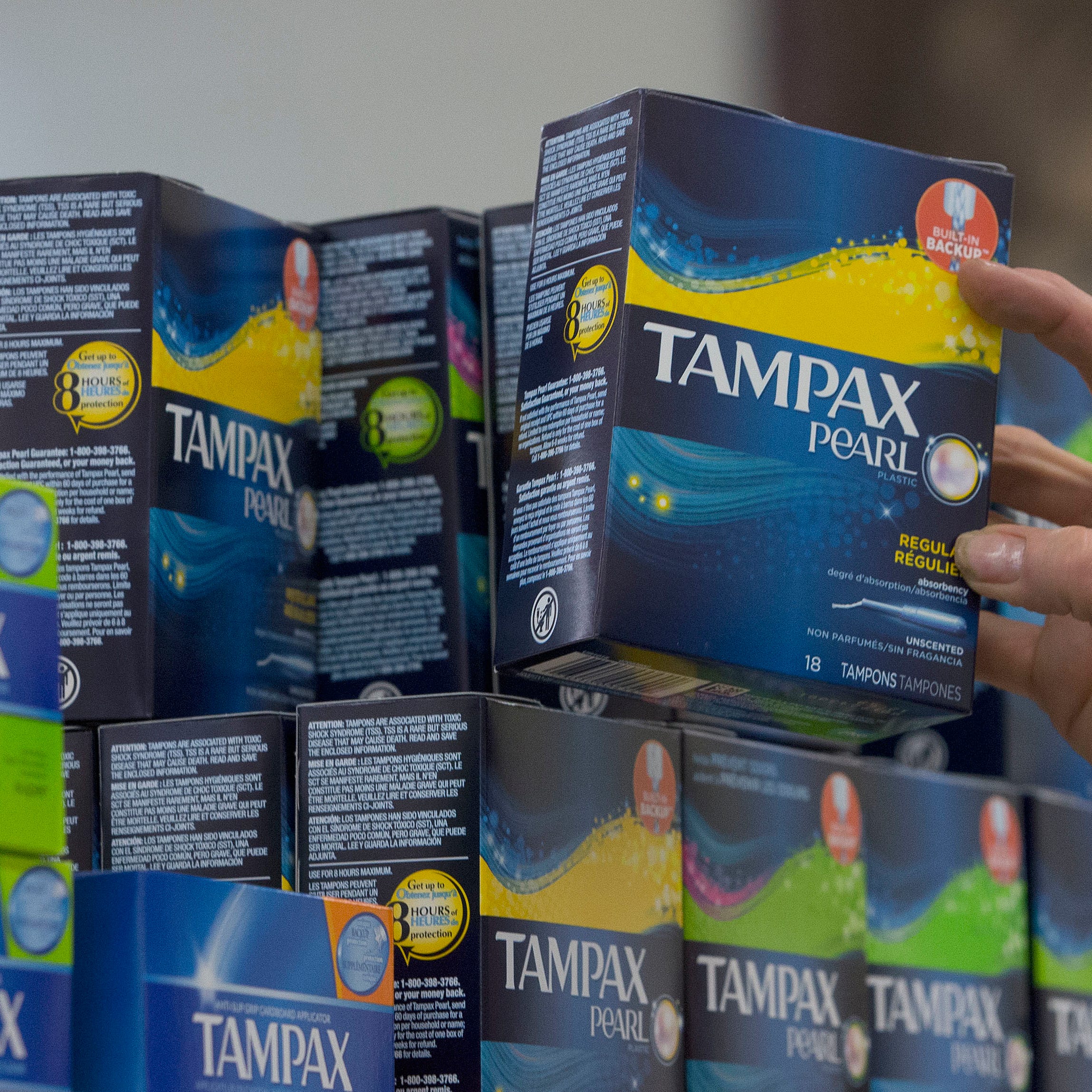 A worker restocks tampons at Compton's Market in Sacramento, California.