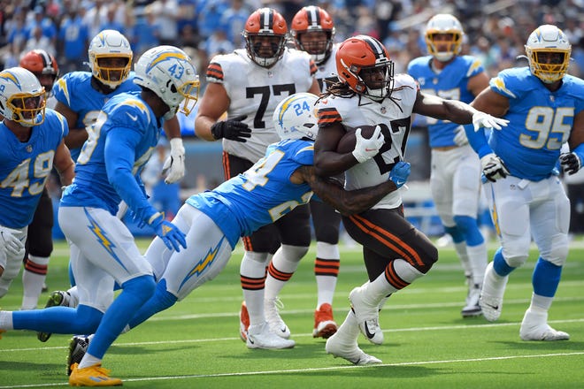 Cleveland Browns running back Kareem Hunt, right, is tackled by Los Angeles Chargers safety Nasir Adderley (24) during the first half of an NFL football game Sunday, Oct. 10, 2021, in Inglewood, Calif. (AP Photo/Kevork Djansezian)