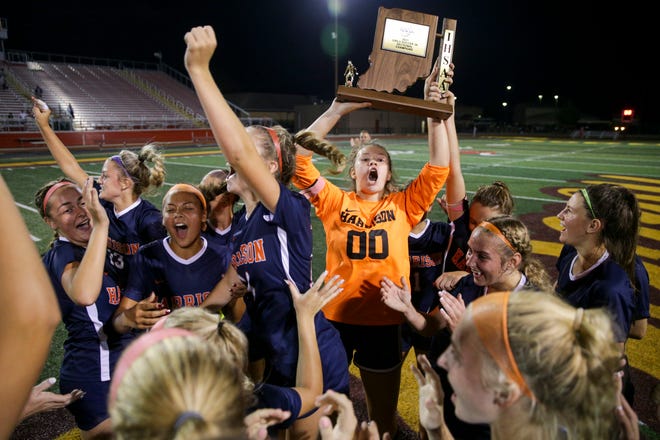 Harrison players celebrate with the sectional trophy after defeating Logansport, 3-0 to the IHSAA Sectional No. 5 girls soccer championship game, Saturday, Oct. 9, 2021 in Lafayette.