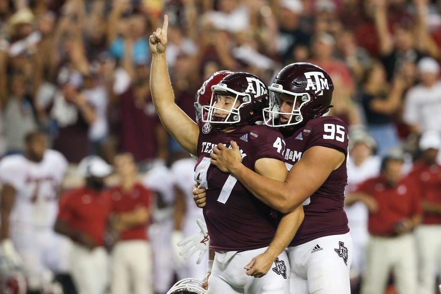 Texas A&M punter Nik Constantinou (95) celebrates with kicker Seth Small after his game-winning field goal against Alabama.