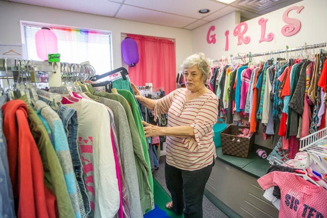 Marcia Bloore looks through items inside Fig Leaf Boutique on Monday, Oct. 11, 2021, in Mishawaka. 
