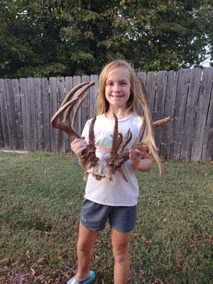 Ella Perkins, 10, shows the rack of a deer she shot last month in Cowley County.