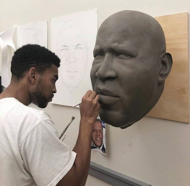 Detroit's Native Mario Moore used silicone, plexiglass, residents and other materials to create hold molds for American business and investor Robert F. Smith. "Men of change" show.