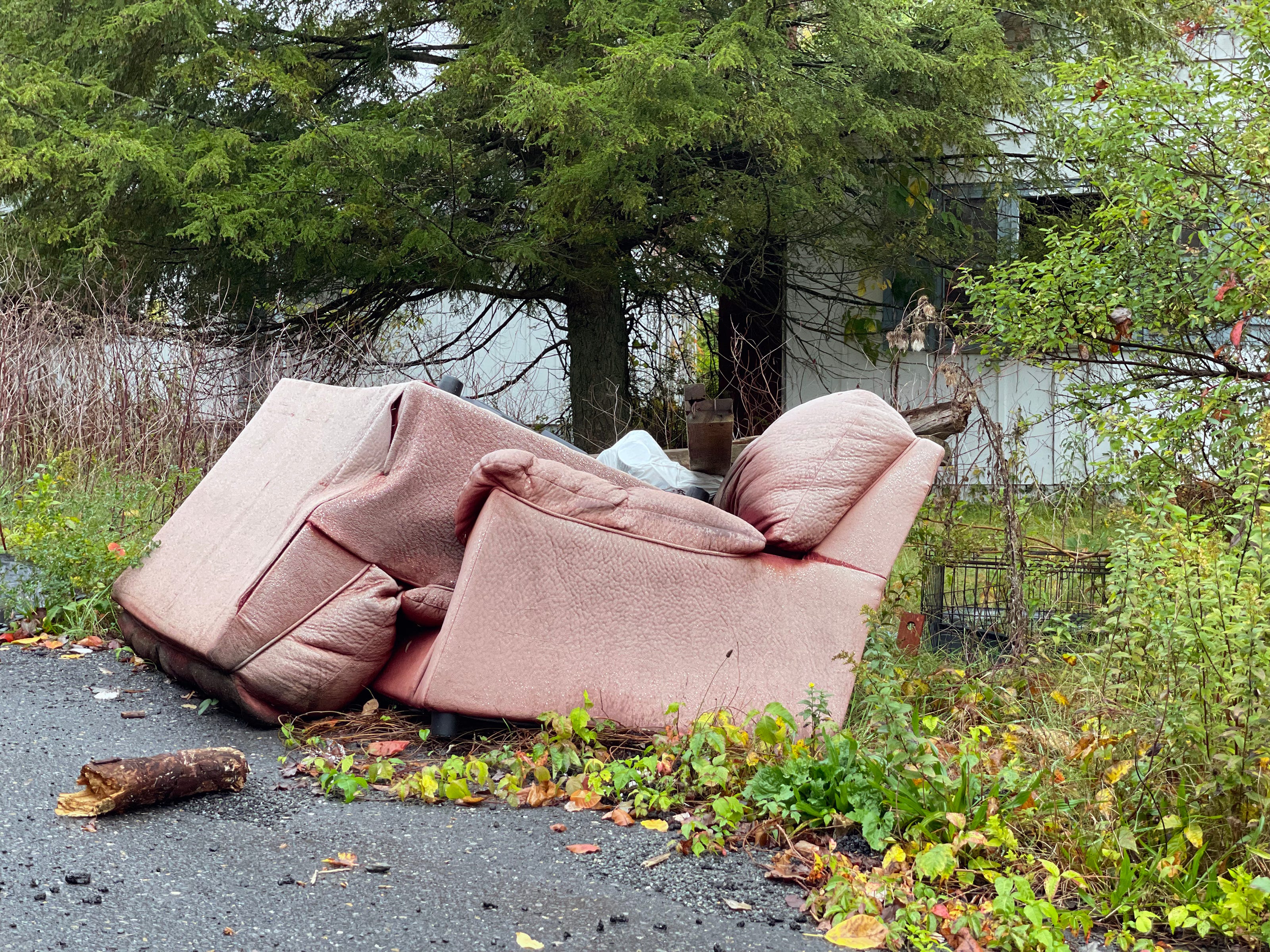 Decrepit furniture sits along the side of the road near the former Birchwood Resort property in Pocono Township. Monroe County is home to numerous abandoned honeymoon resort properties like this one.