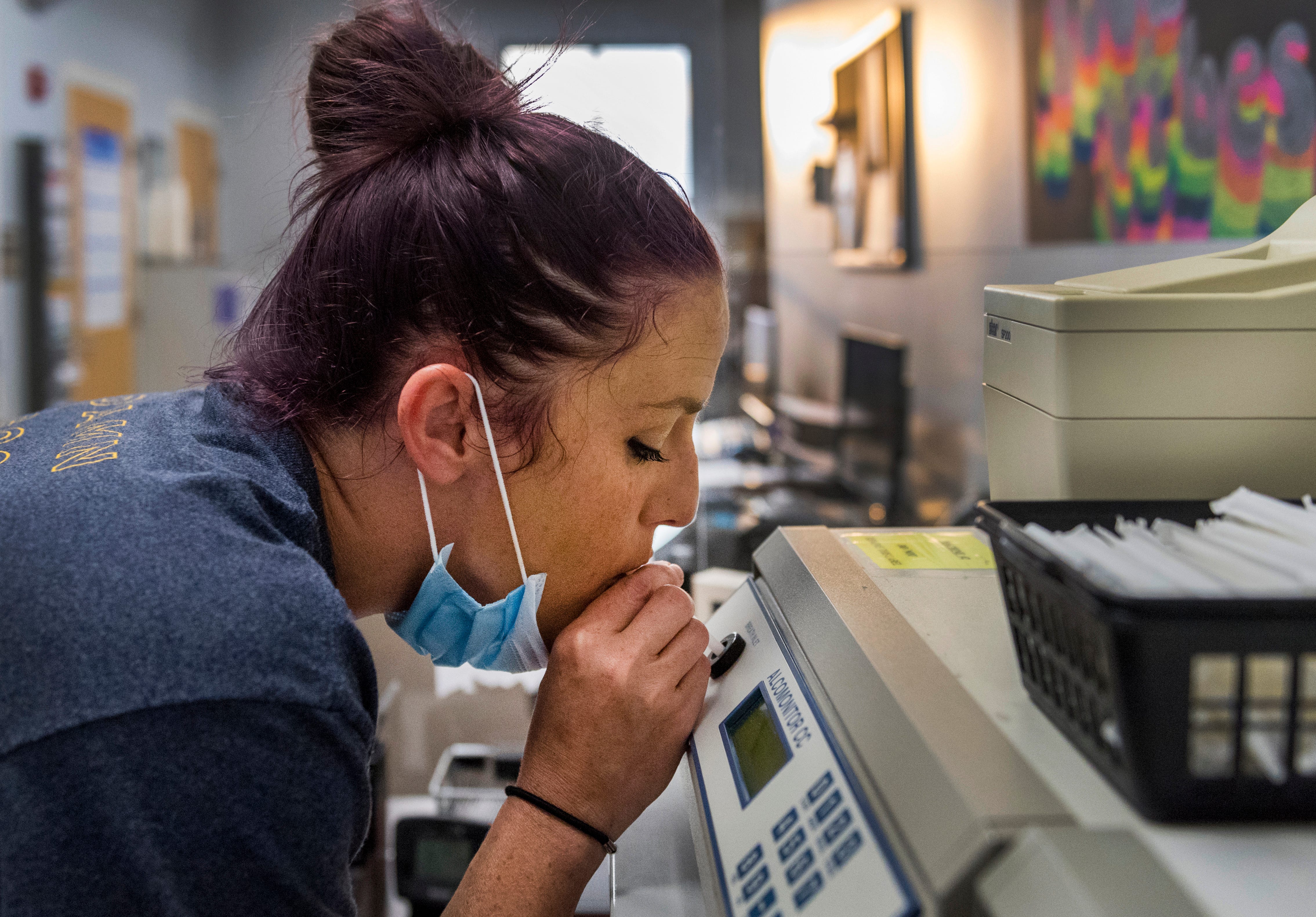 Megan Husk of Evansville blows in a breathalyzer before her drug test for the Vanderburgh County Community Corrections Thursday morning, Aug. 26, 2021.
The county's community corrections program and drug court charge $13 per test. People required to get drug tests as a requirement of their probation must give ABK $100 up front for setup and then $30 for each drug and alcohol urine test.