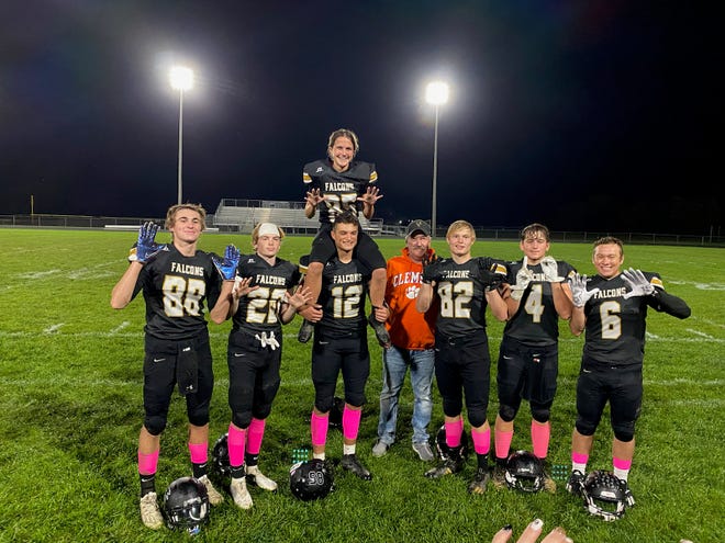 Members of the Winchester football team pose for a photo with freshman kicker Aubrey Weigand (85) following the Golden Falcons' win over Cambridge City Lincoln on Oct. 8. Weigand tied a school record with 10 consecutive extra points made.