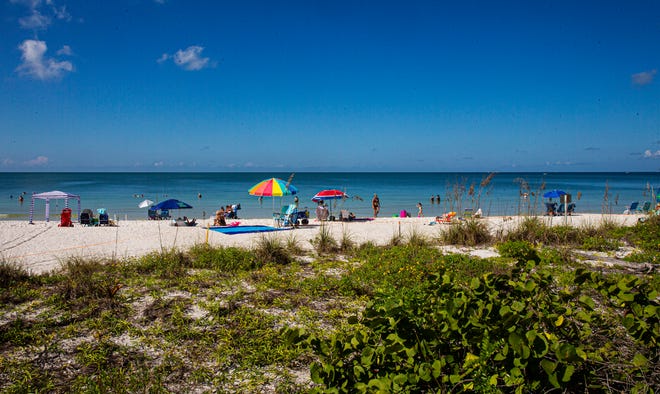 Visitors enjoy a day at the beach on Bonita Beach at beach access 10 on Tuesday, Oct. 12, 2021. Lee County, Bonita Springs and FDEP are spending $2.5 million to add sand to the Little Hickory Island Beach Park area on the north part of Bonita Beach.