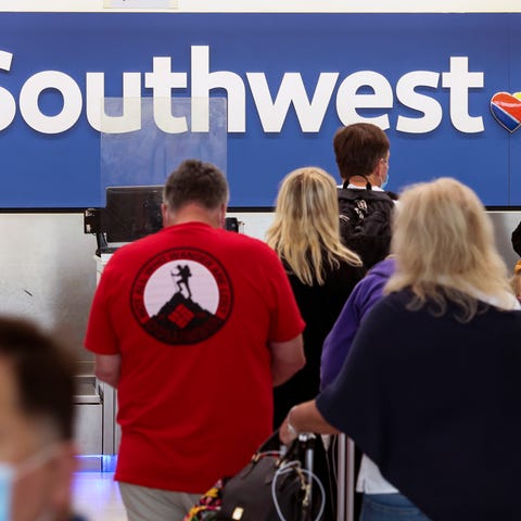 Travelers wait to check-in at the Southwest Airlin