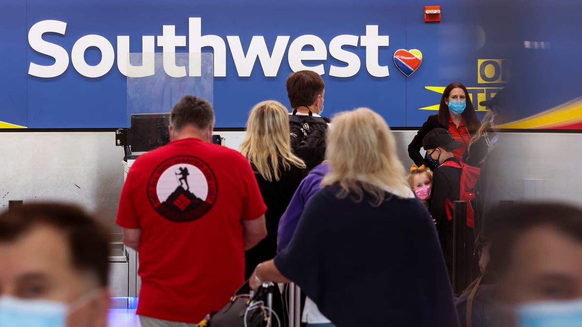 Travelers wait to check-in at the Southwest Airlines ticketing counter at Baltimore Washington International Thurgood Marshall Airport on Oct. 11, 2021.