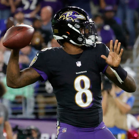 Lamar Jackson passes the ball against the Indianap