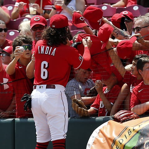 Fans reach out for autographs from Cincinnati Reds