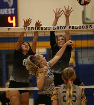 Veribest's Kennadi Wheeless, center, goes up for an attack against Water Valley in a District 7-2A showdown at the Veribest gym on Tuesday, Oct. 12, 2021.