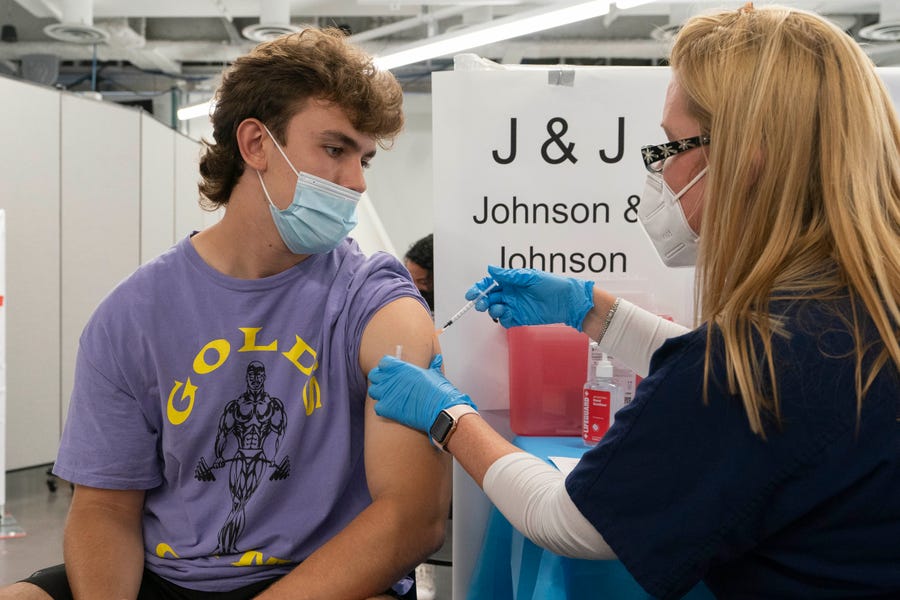 Bradley Sharp, of Saratoga, New York, gets the Johnson & Johnson vaccine from registered nurse Stephanie Wagner in New York.