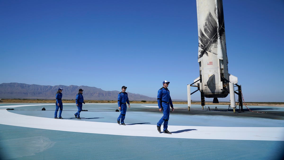 Blue Origin's New Shepard rocket latest space passengers from right Glen de Vries, right, Chris Boshuizen, William Shatner and Audrey Powers walk on the booster rocker landing pad for a media availability at the spaceport near Van Horn, Texas, Wednesday, Oct. 13, 2021.
