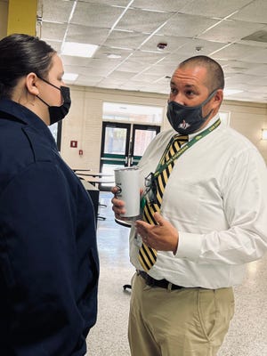 Jeremy Shields, Cleveland County Schools' Principal of the Year, chats with Autum Howell during lunch at Crest High School.