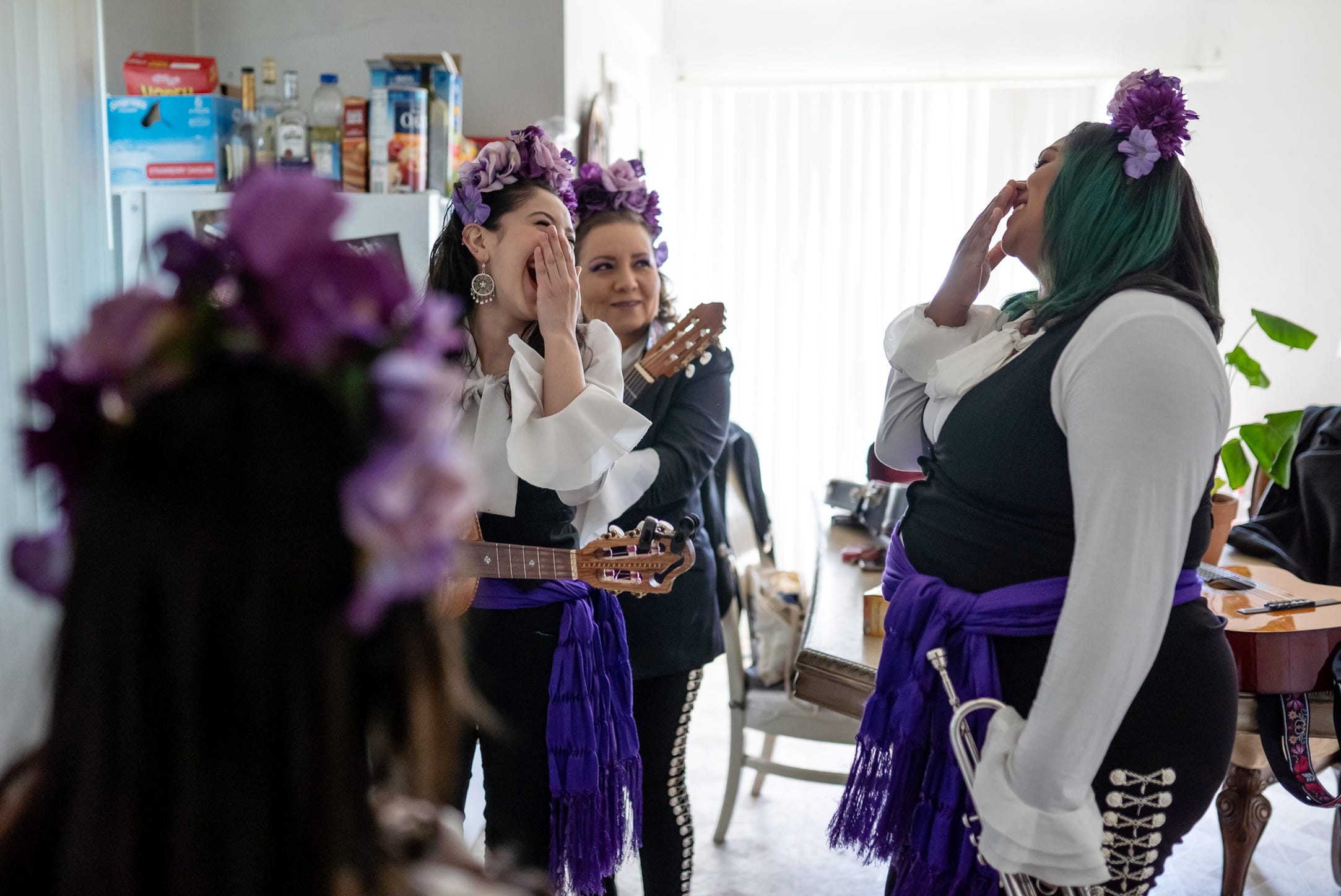 Mariachi Femenil Detroit director Camilla Cantu, left, of Detroit shares a laugh with member Sherray Rowe of Livonia while preparing to leave Cantu's home for a gig on Saturday, May 29, 2021.