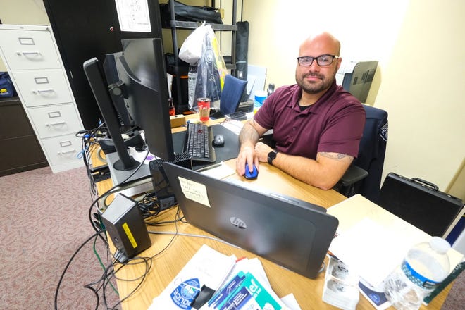 Port Huron Community Service Officer Sam Baker sits at his desk on Thursday, Oct. 14, 2021.
