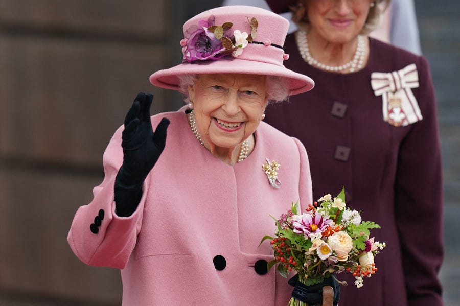 Queen Elizabeth II waves as she leaves after attending the ceremonial opening of the sixth Senedd, the Welsh Parliament, in Cardiff, Wales, on Oct. 14, 2021.