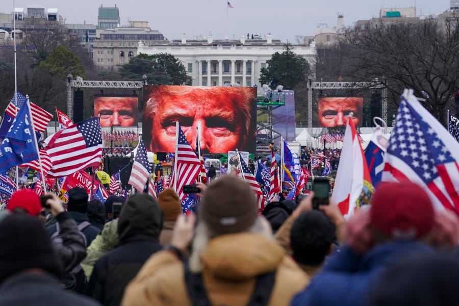 FILE - In this Jan. 6, 2021, file photo, the face of President Donald Trump appears on large screens as supporters participate in a rally in Washington. The House committee investigating the violent Jan. 6 Capitol insurrection, with its latest round of subpoenas in September 2021, may uncover the degree to which former President Donald Trump, his campaign and White House were involved in planning the rally that preceded the riot, which had been billed as a grassroots demonstration. (AP   Photo/John Minchillo, File) ORG XMIT: NY932