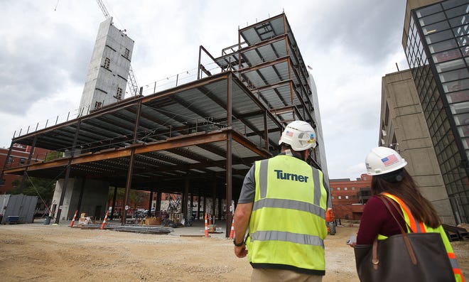 Terry Donovan, project manager for Turner Construction, shows the progress being made on Summa Health's new behavioral health facility to Summa Public Relations Strategist Shannon Kew during a tour of the construction site Thursday in Akron.