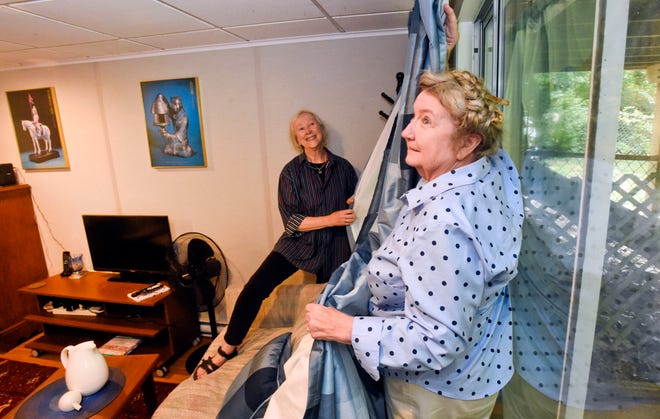 Falmouth residents Marga McElroy, right, and Jane Parhiala prepare accommodations where Afghan evacuees set to be relocated in the town.