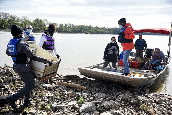 D'Morrion Chatman, a member of YouthBuild, carries a small refrigerator that was lodged on a wing dike during the Stewardship on the Missouri River event Friday. Volunteers from Missouri River Relief, Job Point and AmeriCorps picked up trash on the banks of the river.