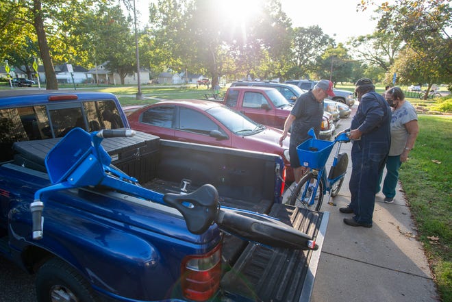 A few lucky folks load up their free commuter bikes that were given away Thursday afternoon at the Topeka Community Cycle Project within the Oakland Community Center. Seven of the 300 bikes were prepared to be given away this day with the rest going to those who put their names on a wait list.