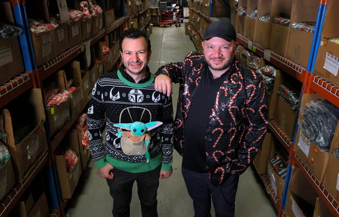 (L to R) Fred and Mark Hajjar, co-founders of UglyChristmasSweater.com inside their 42,000 square foot warehouse in Commerce Township, Michigan on Tuesday, October 12, 2021. Their online retail store has a large supply of Christmas sweaters and other items stuck on freighters off the coast of California. 