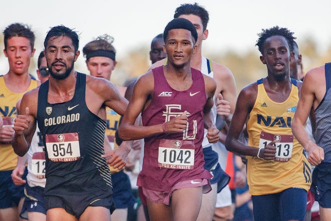 Florida State's Adriaan Wildschutt leads the pack of male runners in the first men's 8k race of the day. Collegiate athletes from across the country compete in the Florida State University Invitational Cross Country meet at Apalachee Regional Park on Friday morning, Oct. 15, 2021. 